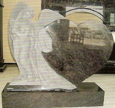 Upright grave memorial with an angel and heart